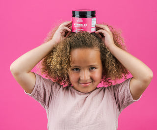 Kids hair growth: Girl with vitamins on her head
