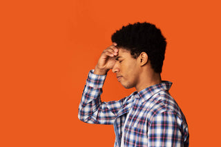 B complex for stress: stressed man holding his forehead
