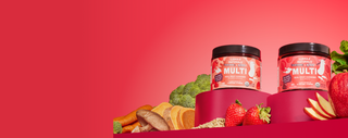 Two containers of 'Super Multi' supplement on a red platform with fruits and vegetables against a red background